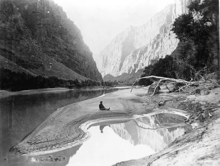 17239 2ND POWELL EXPEDITION. DELLENBAUGH SEATED & REFLECTED IN GREEN RIVER. LADORE CANYON. GRCA 14773. MAY 1871.